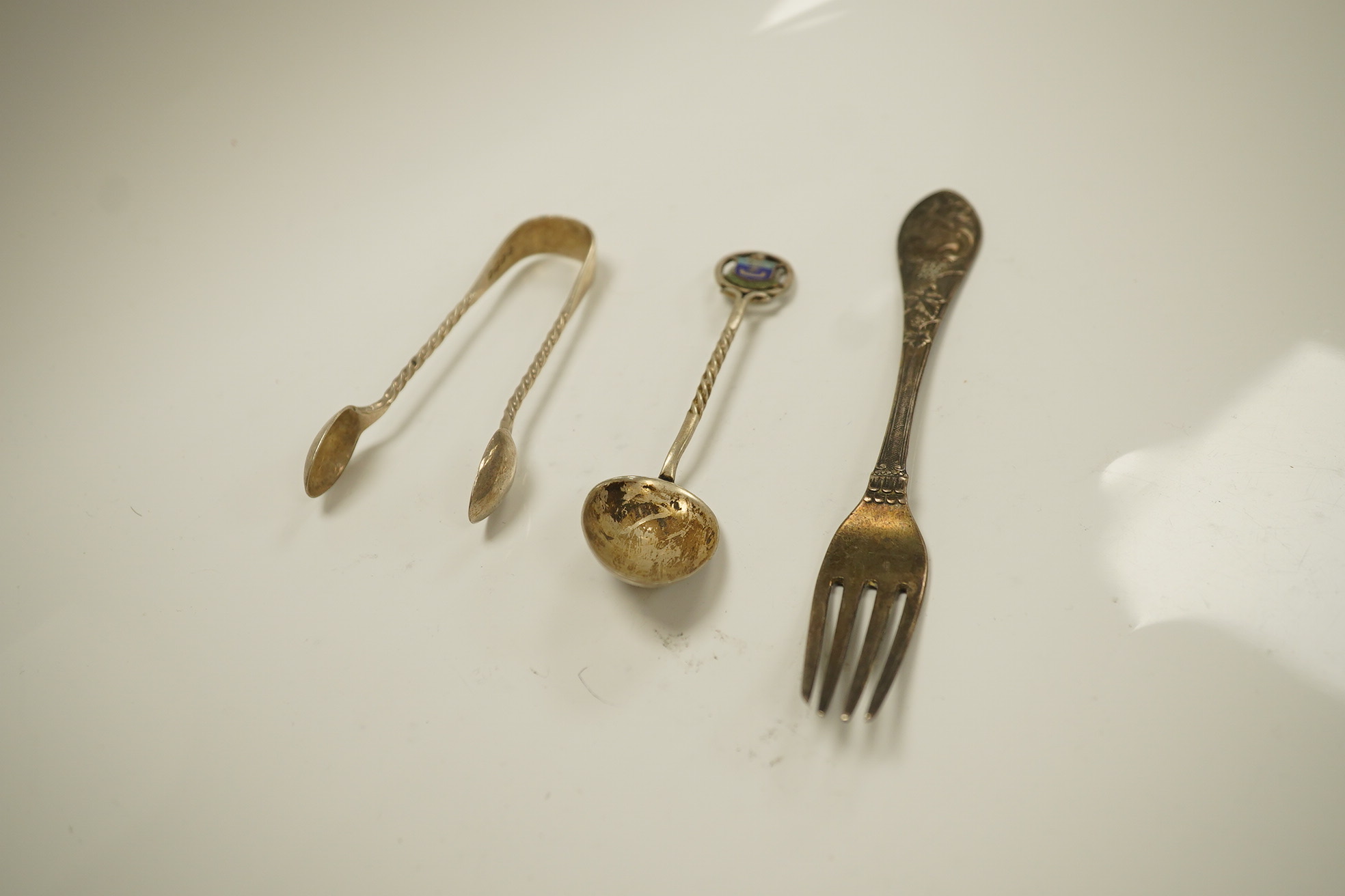 Twenty three items of mainly 19trh century silver fiddle pattern flatware, various dates and makers and a small group of assorted silver and white metal flatware, including Tiffany spoon, 39.8oz. Condition - poor to fair